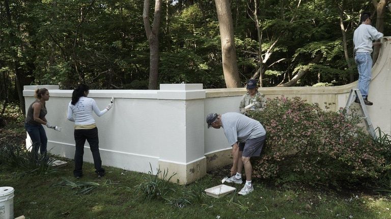 Residents paint a wall in Head of the