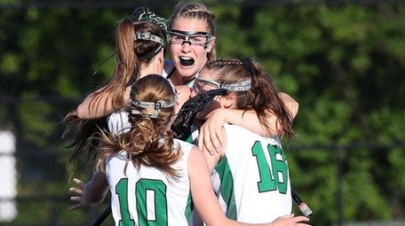 Carle Place's Abby Selhorn, center, celebrates with teammates