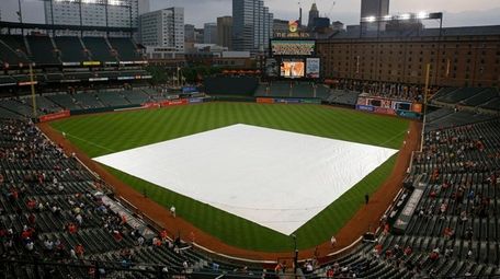 A tarp covers the infield before a game