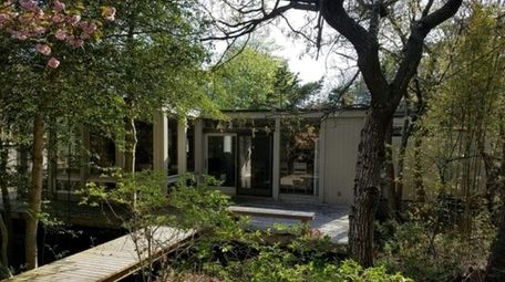 The house is surrounded by gardens and has