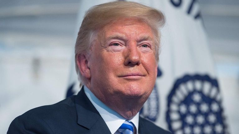 President Donald Trump, seen here on Friday, raises