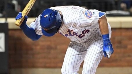Mets catcher Kevin Plawecki slams his bat after
