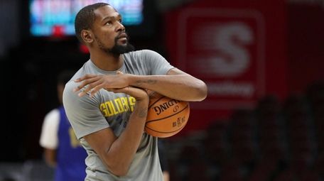 Golden State Warriors forward Kevin Durant warms up