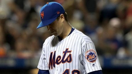Mets pitcher Jacob deGrom walks to the dugout