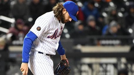 Mets relief pitcher Robert Gsellman kicks the mound