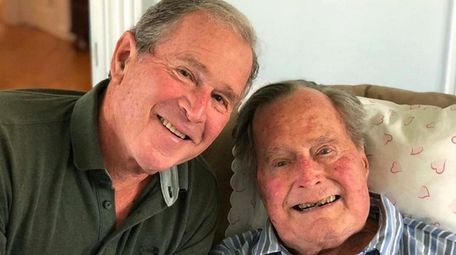 Former Presidents George W. Bush and his father,