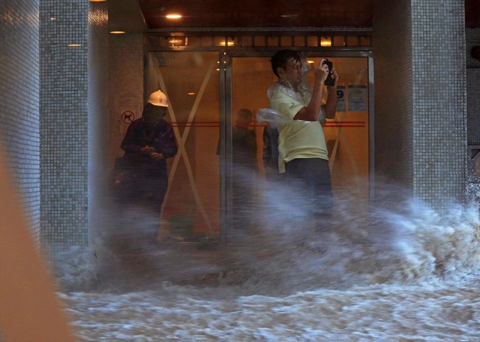 A man takes pictures against strong wind caused