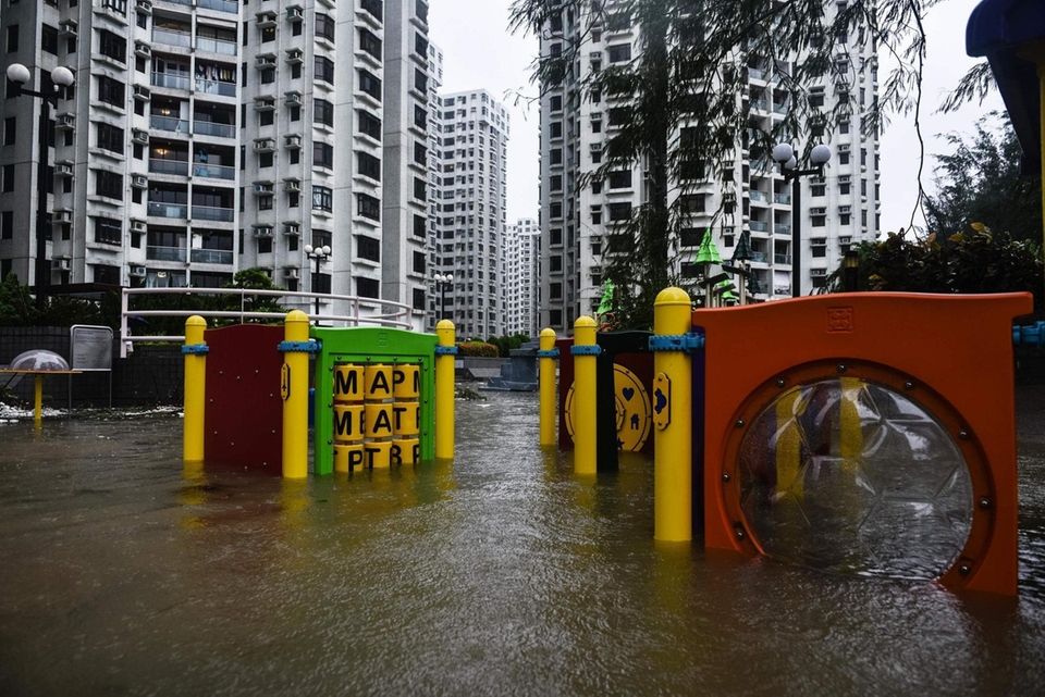 A flooded playground is seen in front of