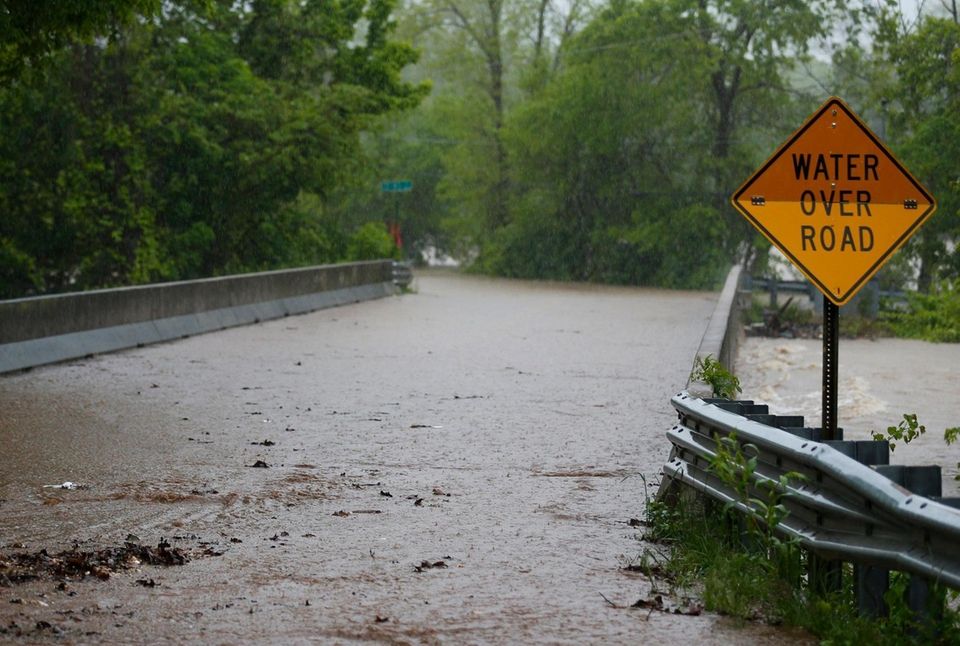 Water begins to cover the Kinser Bridge on