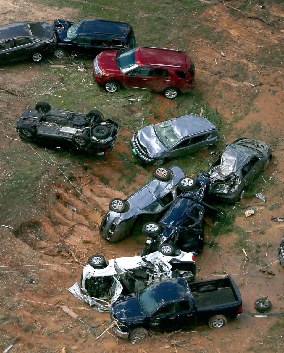 Damaged cars and trucks that were thrown off