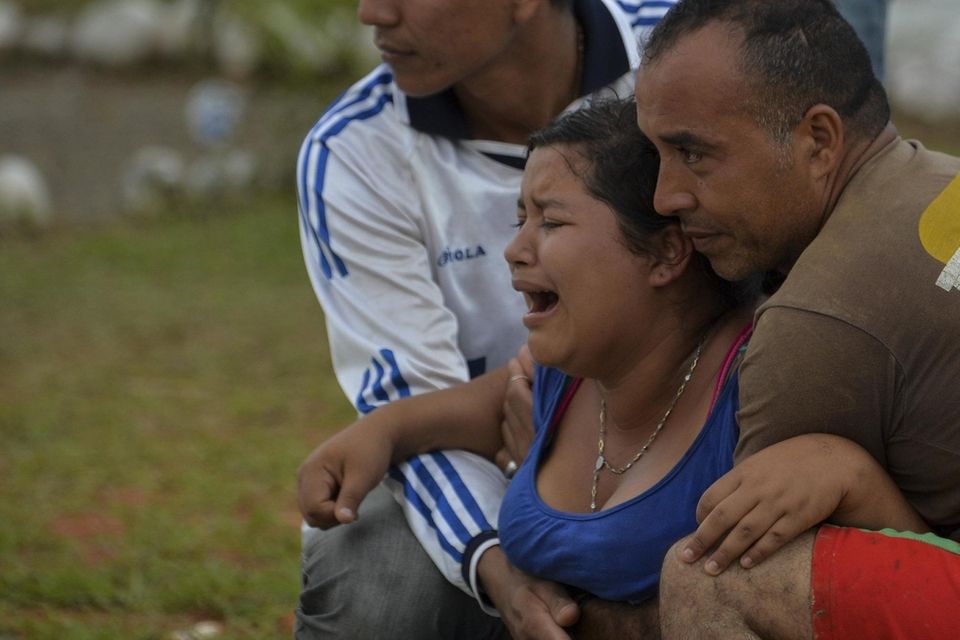 A woman weeps during the funeral of her