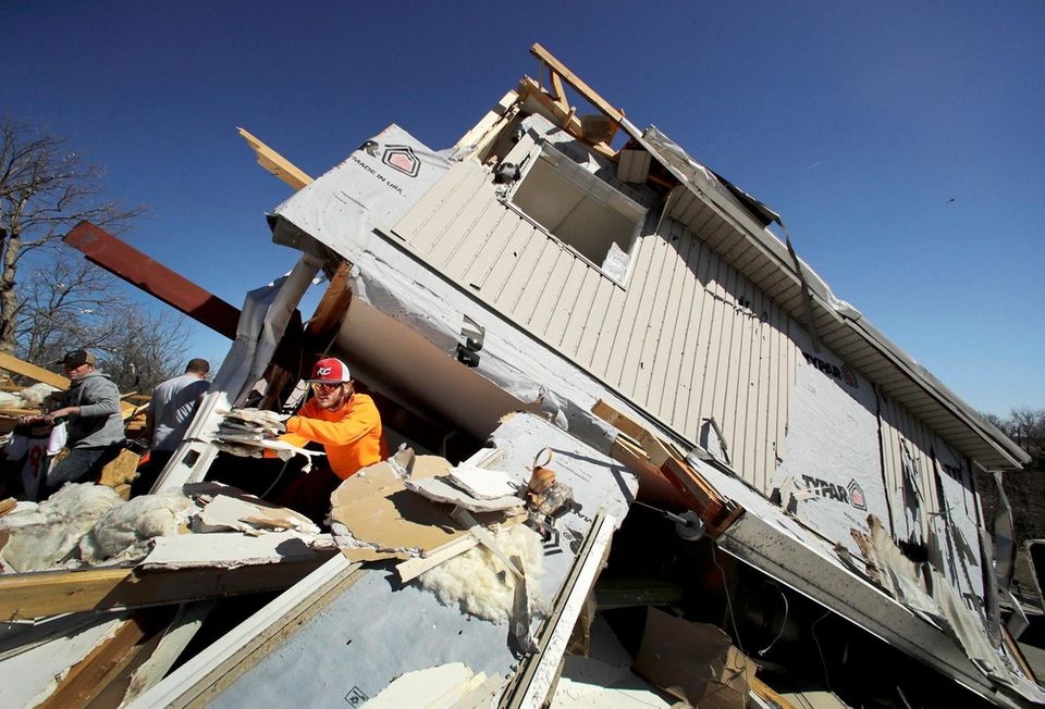 Skyler Jackson salvages items from a friend's destroyed