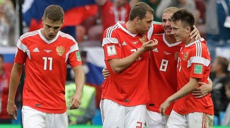 Russia players celebrate after scoring during a Group