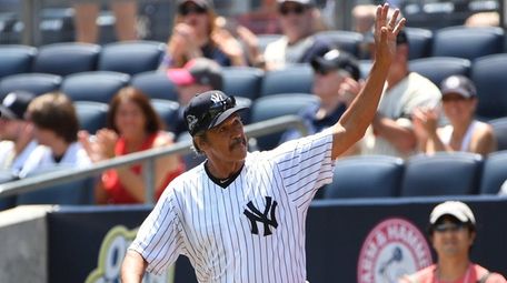 Former New York Yankees player Ron Guidry waves