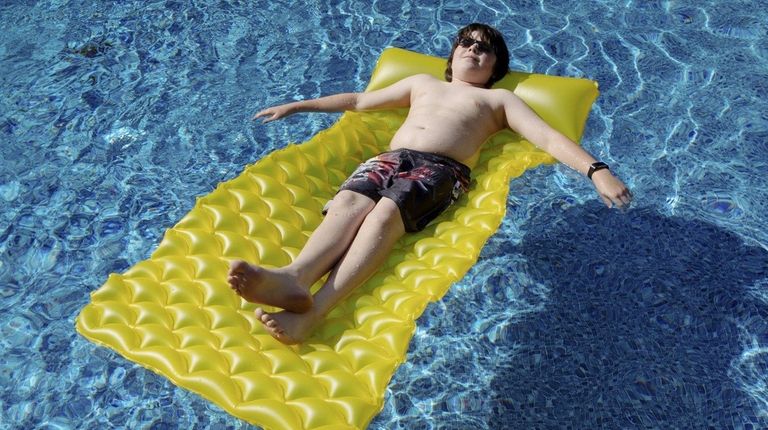 Jonathan DiMarco, 12, of Manorville, cools off in
