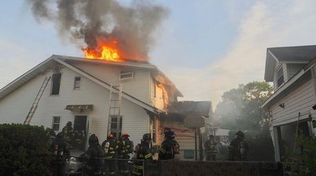 Firefighters from several departments battle a house fire