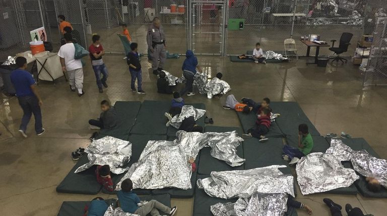 Children are held by U.S. Border Patrol agents