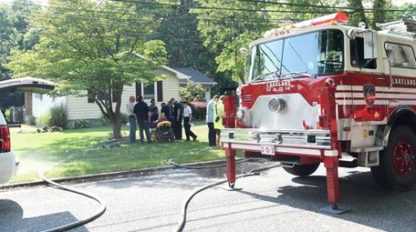 A firefighter is evaluated at the scene of