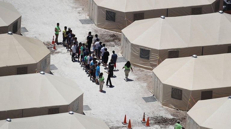 Children and workers are seen Tuesday at an
