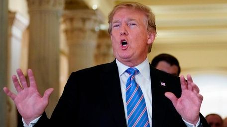President Donald Trump speaks with reporters after meting