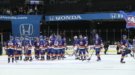 The Islanders acknoledge their fans after their 5-4