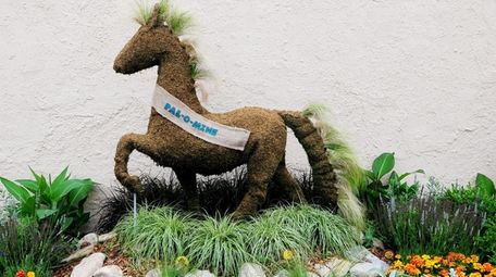 Topiary is displayed in a garden near the