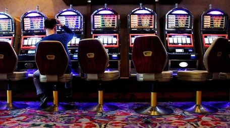 A man uses a video lottery terminal on