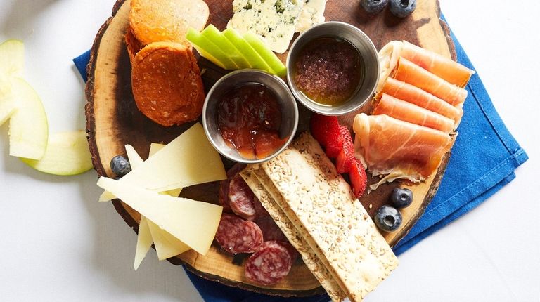 Mixed board of cured meats and cheeses at