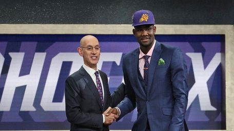 Arizona's Deandre Ayton poses with NBA Commissioner Adam