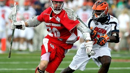 Timmy Trenkle of Stony Brook drives against Virginia's