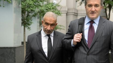 Former SUNY official Alain Kaloyeros, left, arrives at