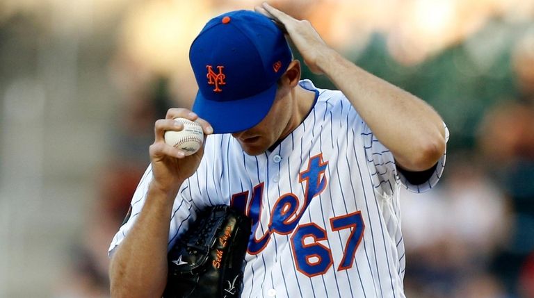 Seth Lugo of the Mets stands on the