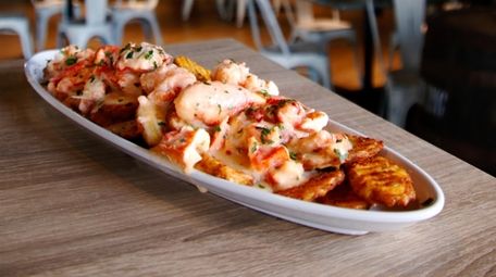 Lobster fries feature seasoned potato wedges topped with