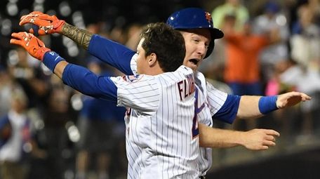 Mets first baseman Wilmer Flores celebrates his walk-off,