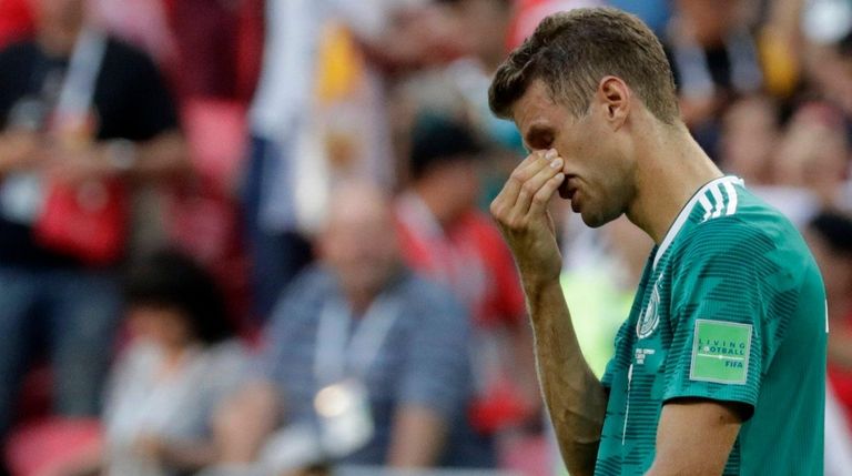 Germany's Thomas Mueller wipes his face after the