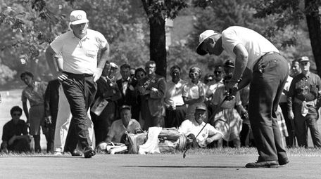 Jack Nicklaus, right, drops a short putt on
