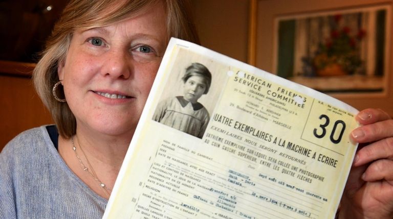Debbie Smith, of Roslyn Heights, with a document