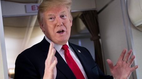 President Trump speaks to the press aboard Air