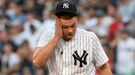 Yankees starting pitcher Sonny Gray reacts after giving