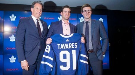 John Tavares poses with Maple Leafs president Brendan