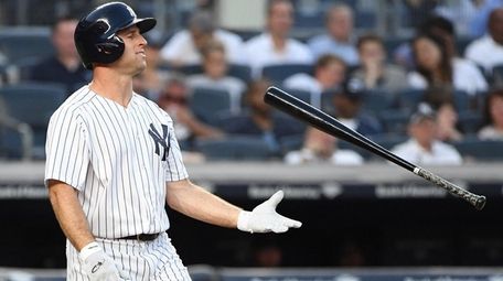 Yankees leftfielder Brett Gardner tosses his bat after