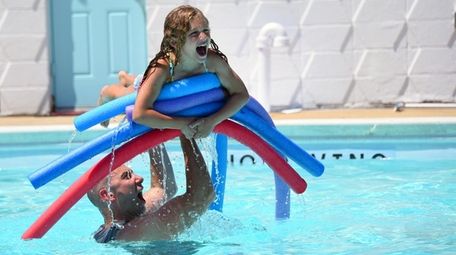 Samantha Rosenthal, 7, of Merrick, cools off at