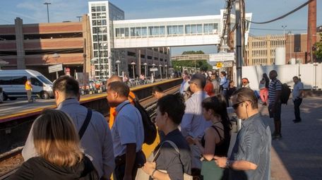 Commuters wait at the LIRR station in Mineola