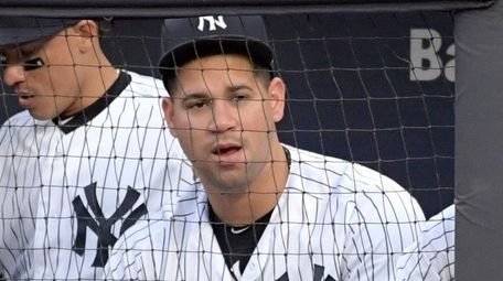 Yankees catcher Gary Sanchez watches from the dugout