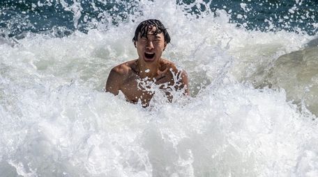 A beachgoer enjoys the surf Friday at Jones