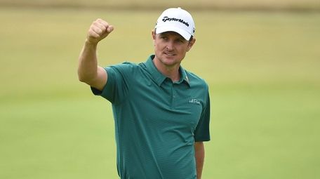 England's Justin Rose reacts after holing his birdie