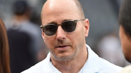 Yankees general manager Brian Cashman looks on from
