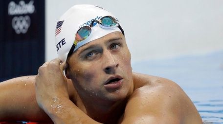 United States' Ryan Lochte checks his time in