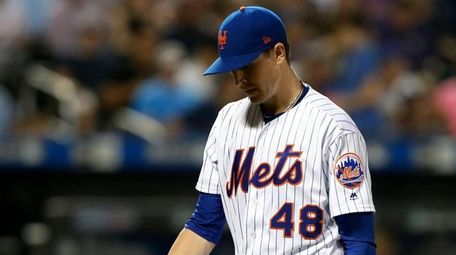Jacob deGrom of the Mets walks to the