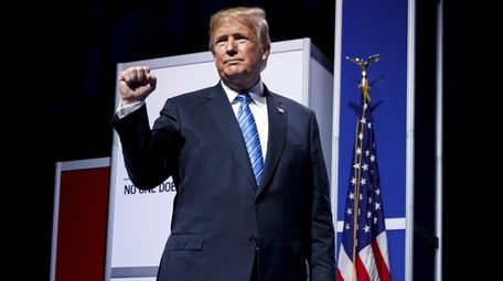 President Donald Trump pumps his fist after speaking